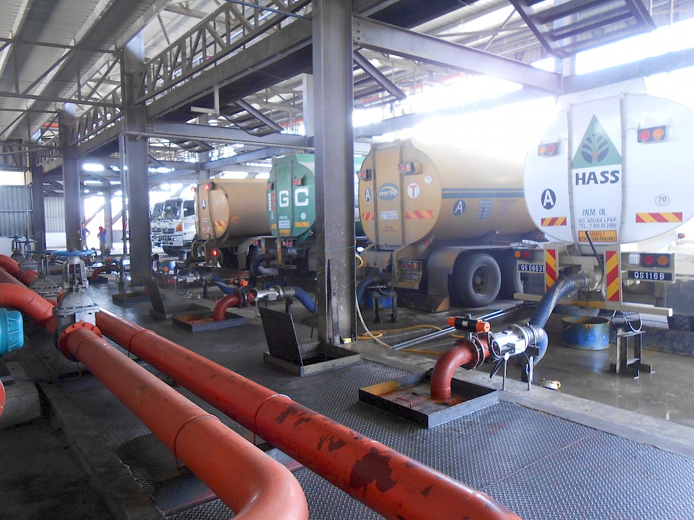 CPO tanker trucks at off-loading bay with inline instrumentation
