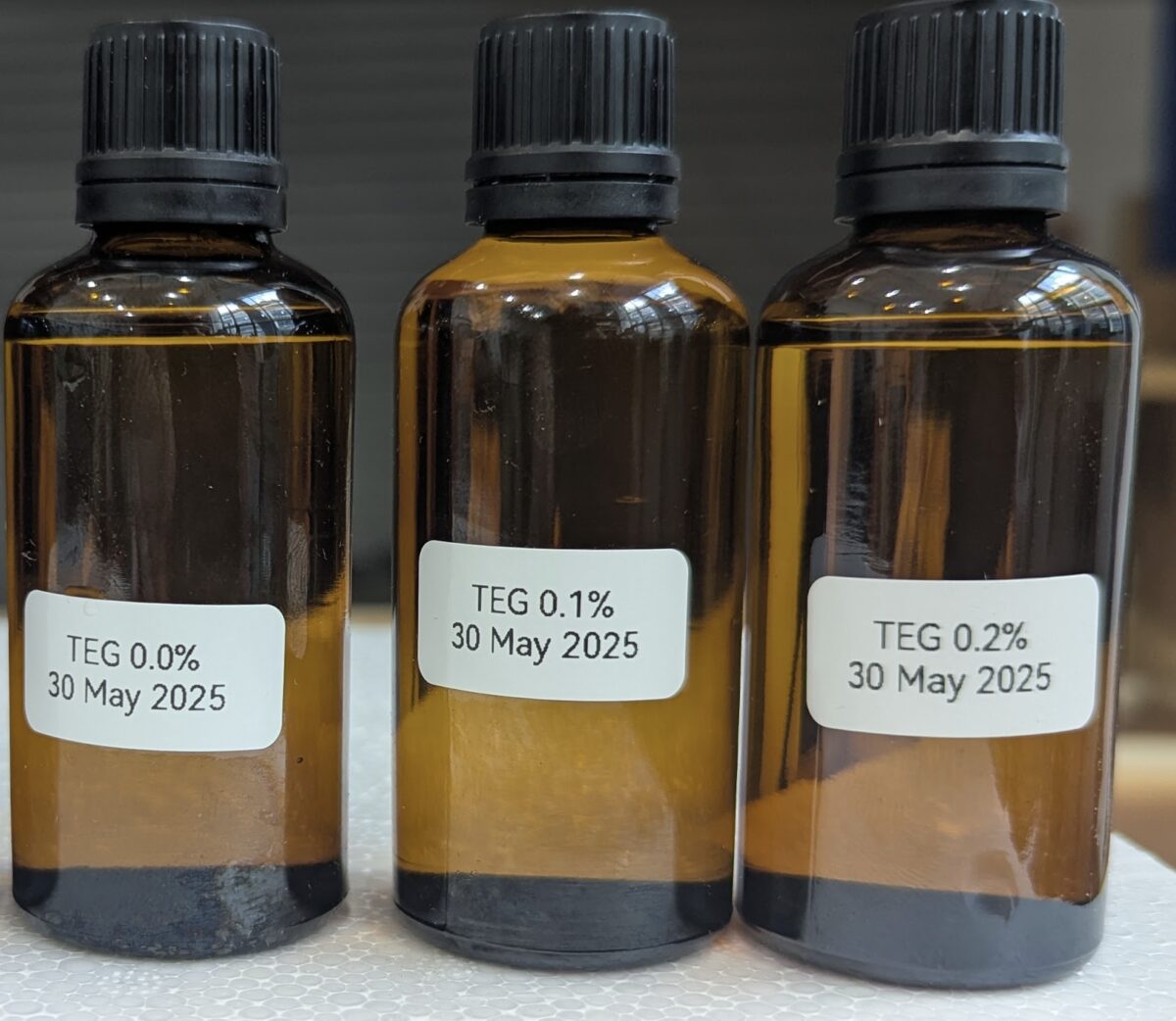 Sample bottles from Test Run 2, 30 May 2025: TEG samples at 0.0%, 0.1%, and 0.2% water content
